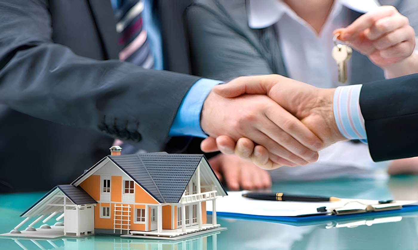 Handshake over a model house and keys as a Phoenix cash sale is agreed
