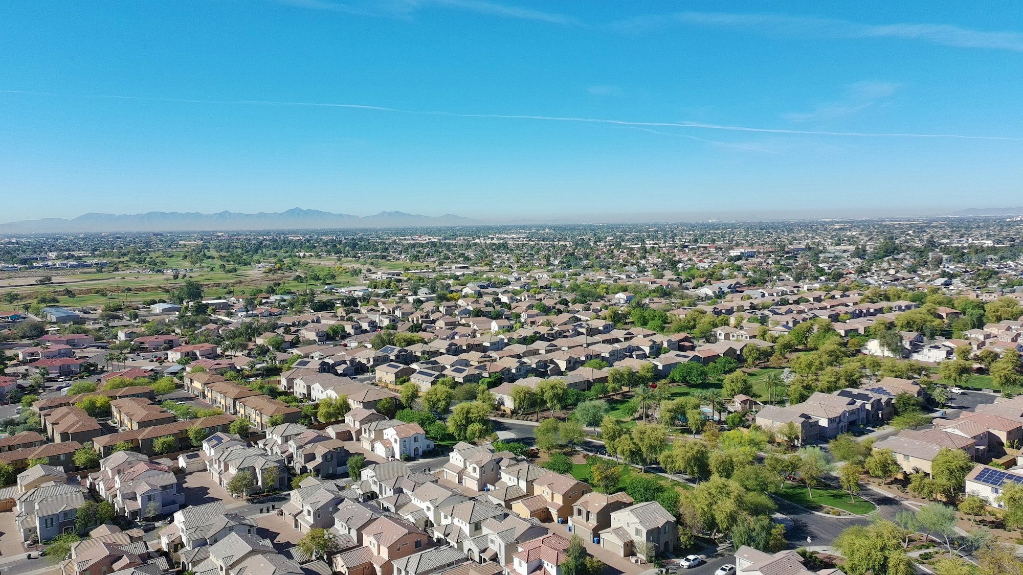 Phoenix area suburban neighborhood of single family homes under a clear desert sky