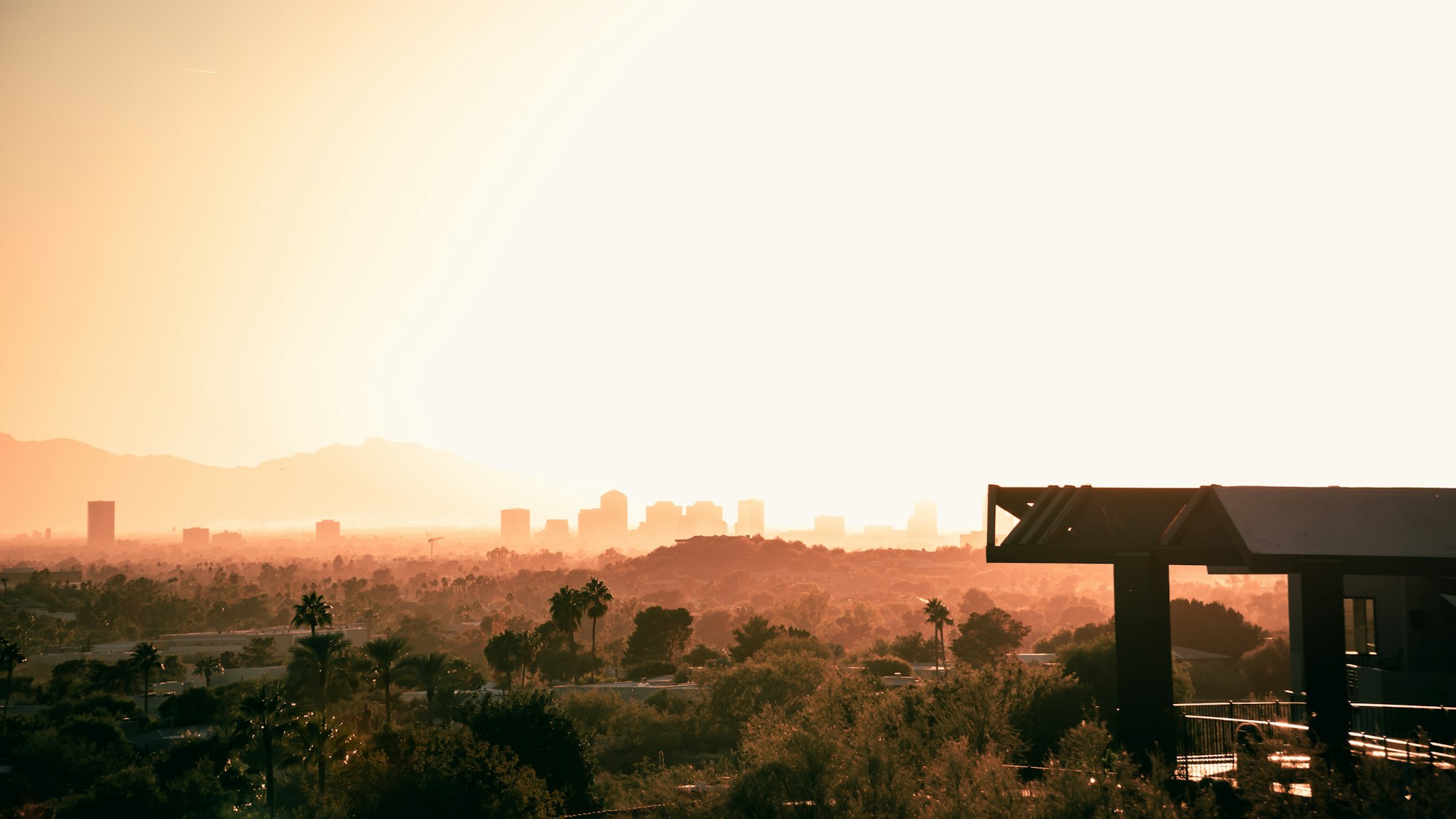 Sun setting over the Phoenix valley skyline and the surrounding mountain ranges